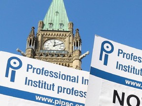 Members of Professional Institute of the Public Service of Canada hold a rally against government cuts on Parliament Hill Friday, November 16, 2012.