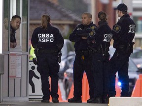 Members of the Canadian Border Services Agency gather at a Canadian border crossing in Surrey, B.C.