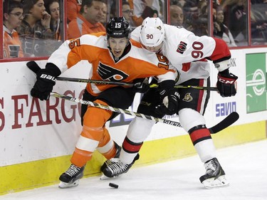 Philadelphia Flyers' Michael Del Zotto (15) and Ottawa Senators' Alex Chiasson (90) battle for the puck during the first period.