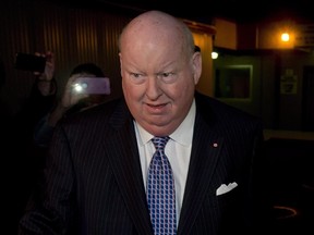 Sen. Mike Duffy is shown leaving Parliament Tuesday, October 22, 2013. A trial for suspended Sen. Duffy will begin next April.