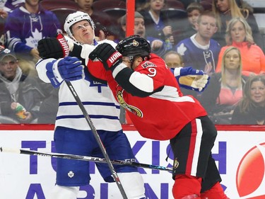 Milan Michalek of the Ottawa Senators hits Dion Phaneuf of the Toronto Maple Leafs during first period NHL action.