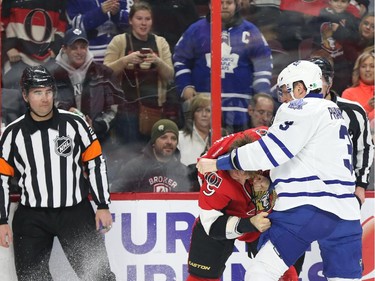 Milan Michalek of the Ottawa Senators is attacked by Dion Phaneuf of the Toronto Maple Leafs during first period NHL action.