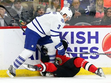 Milan Michalek of the Ottawa Senators is hit by Dion Phaneuf of the Toronto Maple Leafs during first period NHL action.
