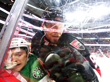Milan Michalek, right, of the Ottawa Senators hits Ryan Garbutt of the Dallas Stars during first period NHL action.