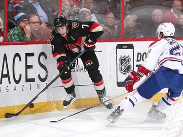 Kyle Turris #7 of the Ottawa Senators stickhandles the puck along the corner boards against Nathan Beaulieu #28 of the Montreal Canadiens.