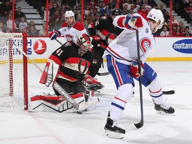 Craig Anderson #41 of the Ottawa Senators makes a save on a deflection by Jiri Sekac #26 of the Montreal Canadiens as Brandon Prust #8 looks on.