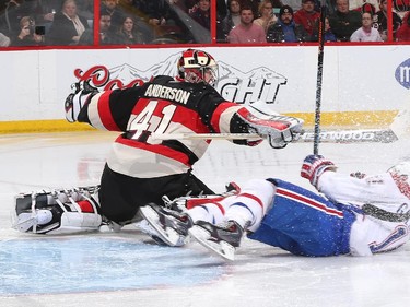 Craig Anderson #41 of the Ottawa Senators narrowly avoids a collision as Brendan Gallagher #11 of the Montreal Canadiens slides through the crease.