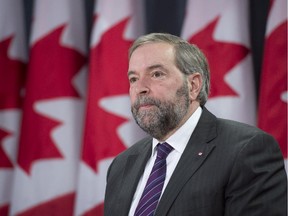 NDP Leader Tom Mulcair reacts to the shooting in France during a news conference Wednesday January 7, 2015 in Ottawa.