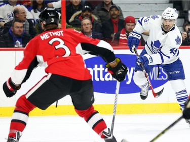Name Kadri of the Toronto Maple Leafs in action against Marc Methot and the Ottawa Senators during second period NHL action.