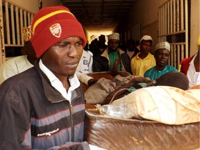 A man injured in a suicide blast is carried by relatives at the General Hospital in northeast Nigerian town of Potiskum on January 12, 2015. Four people were killed and 46 injured when two female suicide bombers detonated their explosives outside a mobile phone market in the town on January 11, 2015.