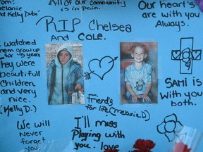 Neighbours erected this memorial to Chelsea and Cole Rodgers outside the Penny Drive townhouse where they died in a deliberately set fire in 2004.