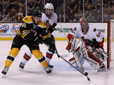 Reilly Smith #18 of the Boston Bruins attempts to shoot on Craig Anderson #41 of the Ottawa Senators in front of the net in the first period at TD Garden on January 3, 2015 in Boston, Massachusetts.