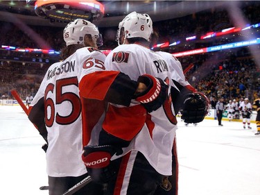 Bobby Ryan #6 of the Ottawa Senators celebrates with teammate Erik Karlsson #65 after he scored against the Boston Bruins in overtime for the win at TD Garden on January 3, 2015 in Boston, Massachusetts.