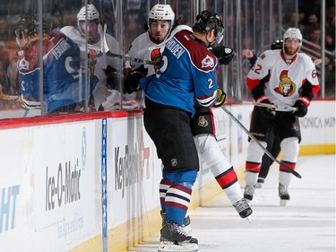 Nick Holden #2 of the Colorado Avalanche puts a hit on Mika Zibanejad #93 of the Ottawa Senators at Pepsi Center on January 8, 2015 in Denver, Colorado.