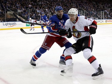 Dan Boyle #22 of the New York Rangers checks Kyle Turris #7 of the Ottawa Senators in the first period.