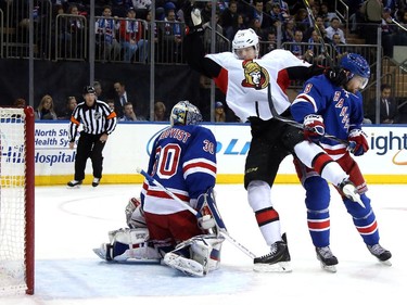 Henrik Lundqvist #30 of the New York Rangers tends goal in the first period as Kevin Klein #8 comes into contact with Alex Chiasson #90 of the Ottawa Senators.