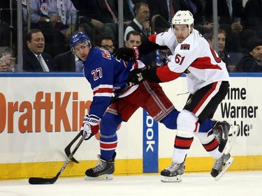 Mark Stone #61 of the Ottawa Senators checks Ryan McDonagh #27 of the New York Rangers.
