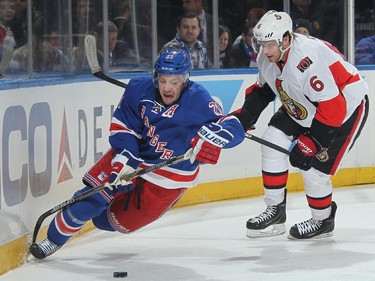 Derek Stepan #21 of the New York Rangers is knocked down by Bobby Ryan #6 of the Ottawa Senators.