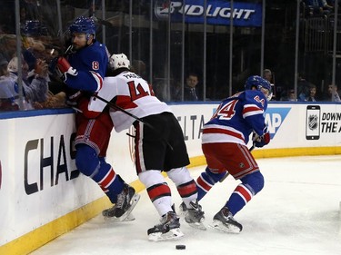 Jean-Gabriel Pageau #44 of the Ottawa Senators checks Kevin Klein #8 of the New York Rangers.