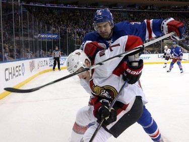 Dan Boyle #22 of the New York Rangers checks Kyle Turris #7 of the Ottawa Senators in the first period.