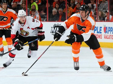 R.J. Umberger #18 of the Philadelphia Flyers takes the puck as Kyle Turris #7 of the Ottawa Senators defends.