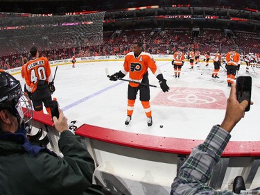 Fans watch as Wayne Simmonds #17 of the Philadelphia Flyers skates during warmups prior to playing the Ottawa Senators.