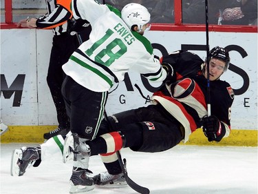 Ottawa Senators' Mark Stone gets hit to the ice by Dallas Stars' Patrick Eaves during first period NHL hockey action.