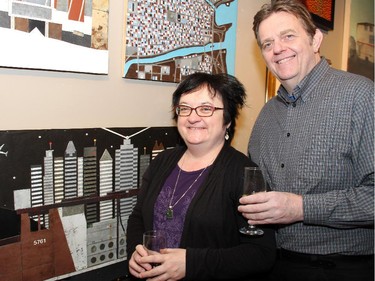 Penny McCann, director of SAW Video Media Art Centre, and her husband, visual artist Eric Walker, alongside his mixed-media works, at the vernissage for Cube Gallery's 10th anniversary exhibition, held Sunday, January 11, 2015.