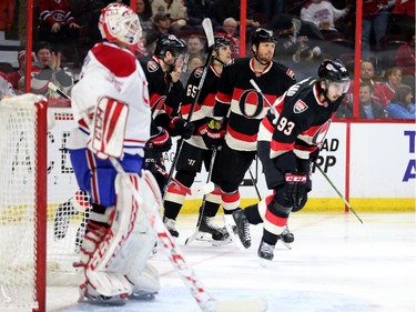Players celebrate the first goal of the game scored by Mika Zibanejad, right, on Dustin Tokarski in the first period.