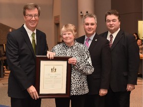 Margaret Knight receives the Mayor's City Builder Award from Mayor Jim Watson while Mark Taylor and Rick Chiarelli (right) look on.
