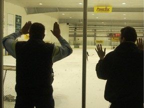 Parents cheer and bang on the glass during a boy's hockey game at the Challenge Cup in Burnaby on May 18, 2002.