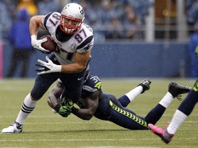 In this Oct. 14, 2012, file photo, New England Patriots' Rob Gronkowski (87) is tackled by Seattle Seahawks' Kam Chancellor in the second half of an NFL football game in Seattle. The teams meet this Sunday for the Super Bowl.