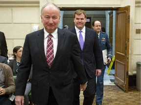Rob Nicoholson, Minister of National Defence is flanked by Foreign Affairs Minister John Baird aned Chief of Defence staff General Tom Lawson as they make their to appear at the Joint Meeting of the Standing Committe on Foreign Affairs and International Development on Canada's response to ISIL, on Parliament Hill in Ottawa, Thursday, Jan.29, 2015.