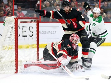 Robin Lehner of the Ottawa Senators makes the save as Bobby Ryan, middle, and Tyler Seguin of the Dallas Stars battle in front of the net during second period NHL action.