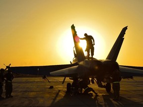 Royal Canadian Air Force ground crew perform post flight checks on a CF-18 fighter jet in Kuwait after a sortie over Iraq during Operation IMPACT on November 3, 2014.   Photo: Canadian Forces Combat Camera, DND IS2014-5026-03 ORG XMIT: IS2014-5026 ORG XMIT: POS1411041252298866  ///fo122714-fisher  fo123014-fisher