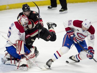 Ottawa Senators left wing Clarke MacArthur collides with Montreal Canadiens goalie Dustin Tokarski as Sergei Gonchar tries to control the puck during first periond NHL action.