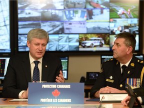 Prime Minister Stephen Harper and York Regional Police Chief Eric Jolliffe take part in a roundtable discussion with law enforcement officials regarding issues related to national security on evolving threats of terrorism and extremism, in Aurora, Ont. earlier this week.