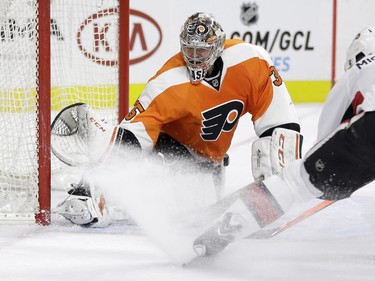 Ottawa Senators' Milan Michalek (9), of the Czech Republic, cannot get a shot past Philadelphia Flyers' Steve Mason (35) during the first period.