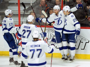Tampa Bay Lightning's Steve Stamkos, second from right, celebrates a second period goal with teammates while taking on the Ottawa Senators in NHL hockey action in Ottawa on Sunday, Jan 4, 2015.