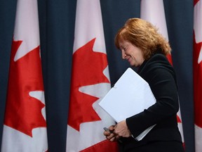 Suzanne Legault, Information Commissioner of Canada, leaves a press conference at the National Press Theatre in Ottawa, Thursday Oct. 17, 2013. The press conference was following the tabling of her annual report in the House of Commons.