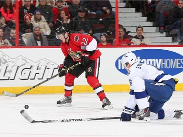 Erik Condra #22 of the Ottawa Senators looks to make a pass against a defending Anton Stralman #6 of the Tampa Bay Lightning at Canadian Tire Centre on January 4, 2015 in Ottawa, Ontario, Canada.