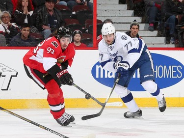Mika Zibanejad #93 of the Ottawa Senators tips the puck past Victor Hedman #77 of the Tampa Bay Lightning at Canadian Tire Centre on January 4, 2015 in Ottawa, Ontario, Canada.