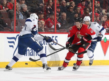 Mark Stone #61 of the Ottawa Senators tips the puck past Victor Hedman #77 of the Tampa Bay Lightning at Canadian Tire Centre on January 4, 2015 in Ottawa, Ontario, Canada.