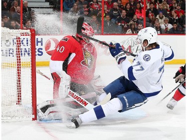 Robin Lehner #40 of the Ottawa Senators makes a save against a sliding Victor Hedman #77 of the Tampa Bay Lightning at Canadian Tire Centre on January 4, 2015 in Ottawa, Ontario, Canada.