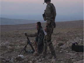 Canadian special forces help Kurds operate a mortar. Photo courtesy Canadian Forces.