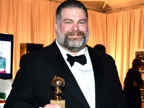 Dean DeBlois holds his Golden Globe statue.