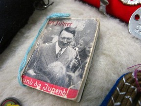 This photo dated Friday, Sept. 19, 2014, shows a tiny Hitler propaganda booklet at an auction house in Anchorage, Alaska. I