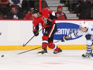 Alex Chiasson #90 of the Ottawa Senators shoots the puck against Jake Gardiner #51 of the Toronto Maple Leafs.