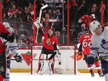 Craig Anderson #41 of the Ottawa Senators raises his stick after the final whistle to celebrate the win against the Toronto Maple Leafs.