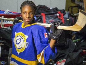 Yassine Diabate, an 11-year-old student at Ecole Saint-Anne, poses with her new hockey equipment, donated by the Ottawa Girls Hockey Association, at Patro d'Ottawa Friday December 19, 2014. The OGHA has collected equipment for 35 girls and will give them hockey lessons on an outdoor rink in January in a free program that's to last seven weeks.  (Darren Brown/Ottawa Citizen)